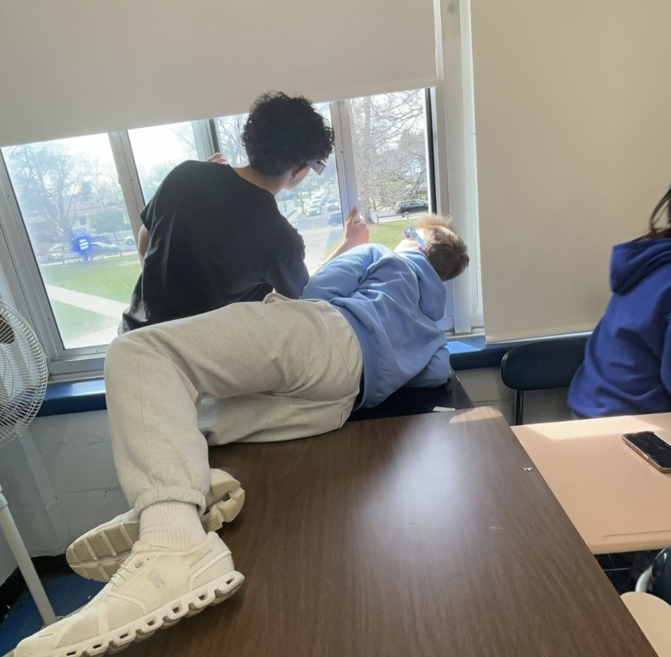 Junior Alex Tomalski falls on a table as a result of Marco's temper tantrum. (Source by Grace Leonard)